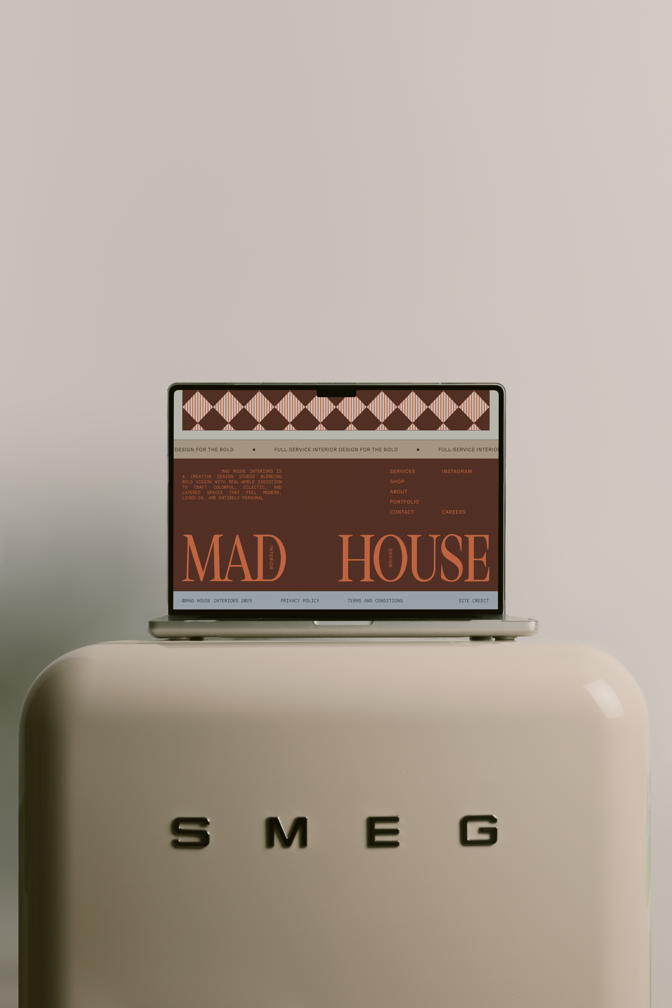 Image of a laptop with a website on top of a Smeg fridge